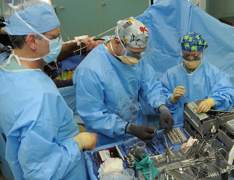US Navy doctors perform an open reduction internal fixation operation on the femur.